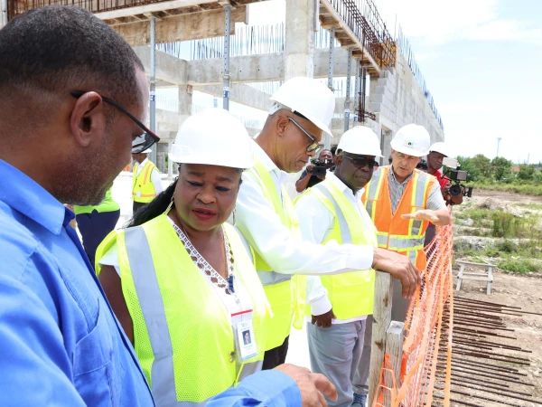 Wolfgang Greiger, Contractor and President of All Bahamas Construction (far right) explains to Prime Minister Davis and Health Minister Dr. Darville some of the construction works that have been completed thus far on the new Freeport Health Campus, during a tour of the site, September 4, 2026.
